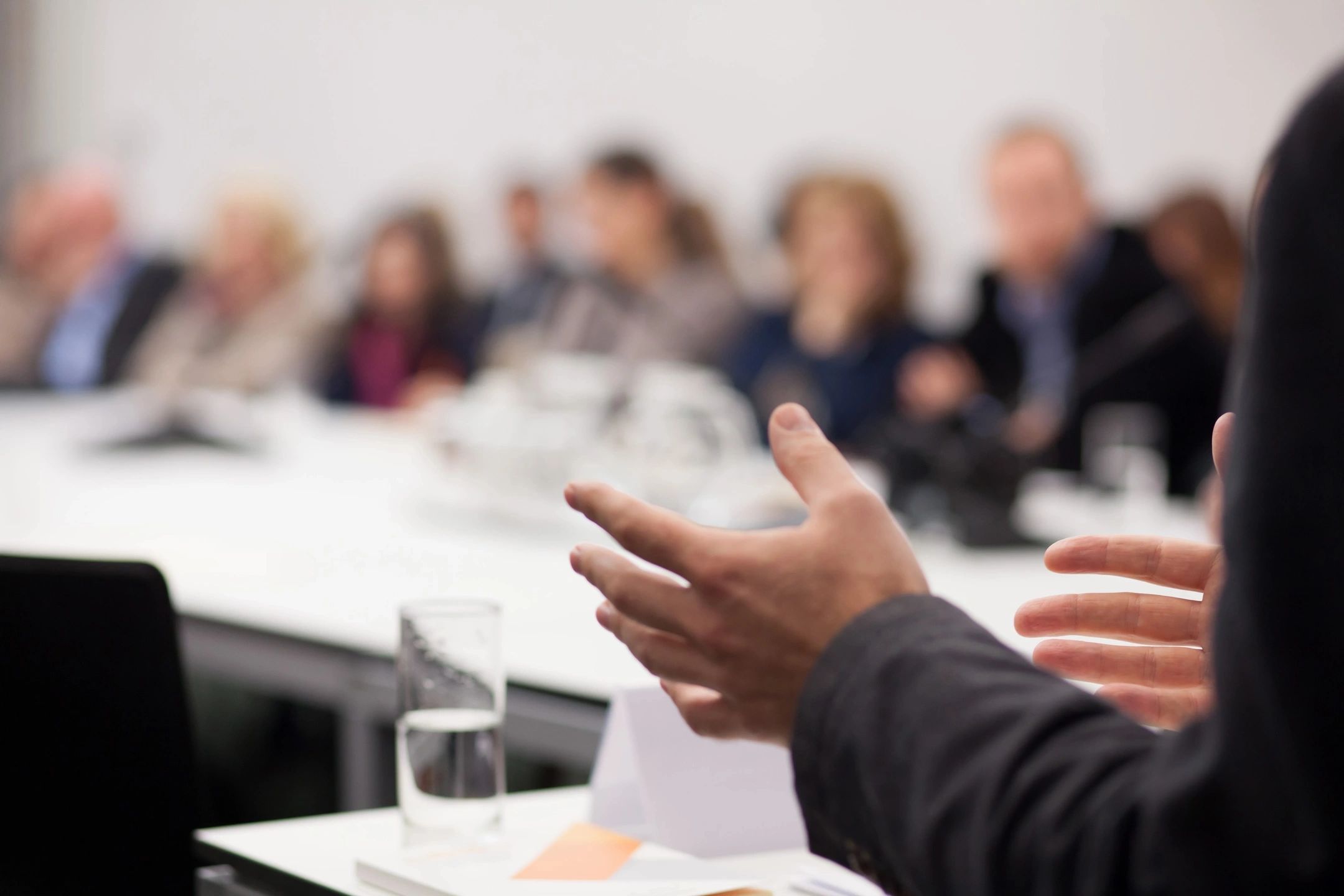 Shareholders discussing business matters and making decisions during a corporate meeting.